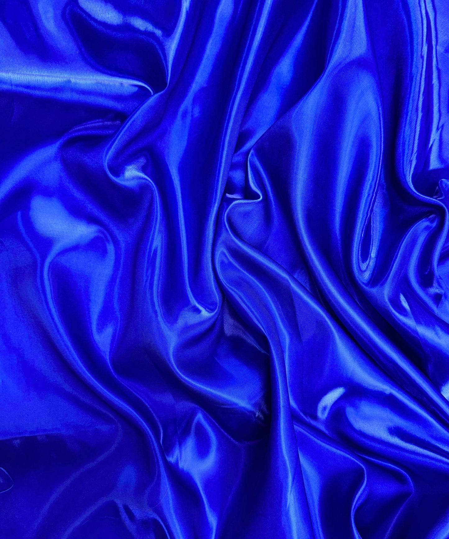 Royal blue liquid bridal satin fabric with ultra-glossy finish, fluid drape, and silky smooth texture – perfect for gowns and elegant décor.