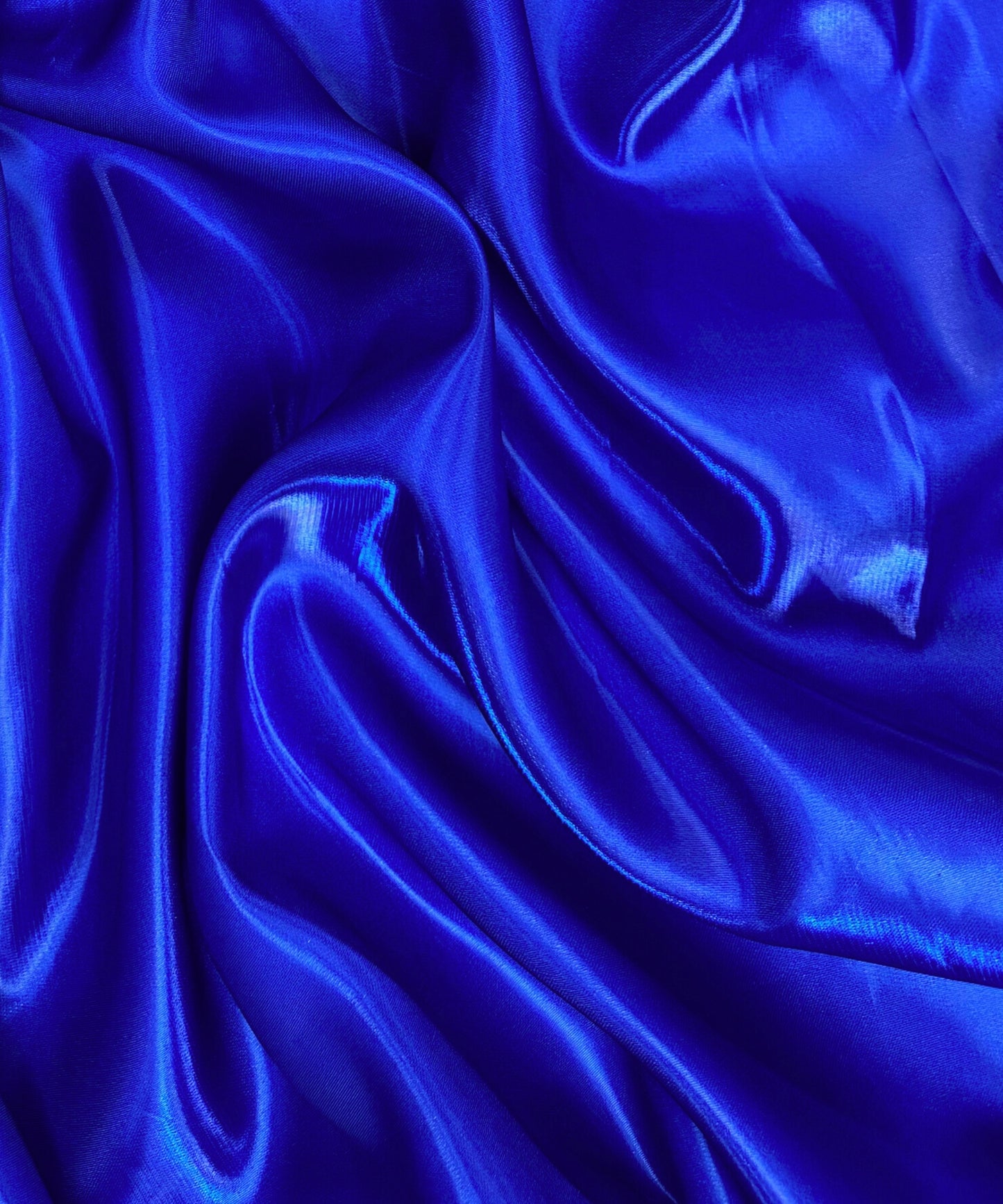 Royal blue liquid bridal satin fabric with ultra-glossy finish, fluid drape, and silky smooth texture – perfect for gowns and elegant décor.