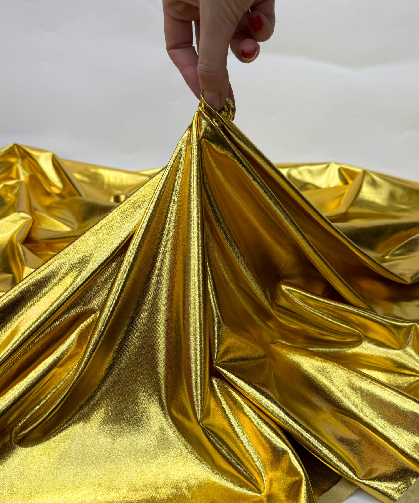 Close-up of metallic gold fabric. gold Metallic Stretch Foil Lame fabric
