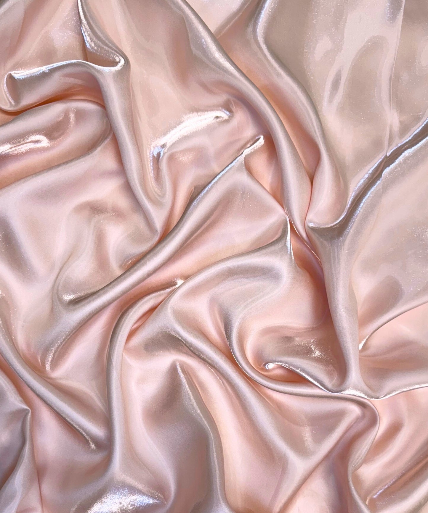 Blush liquid bridal satin fabric with ultra-glossy finish, fluid drape, and silky smooth texture – perfect for gowns and elegant décor.