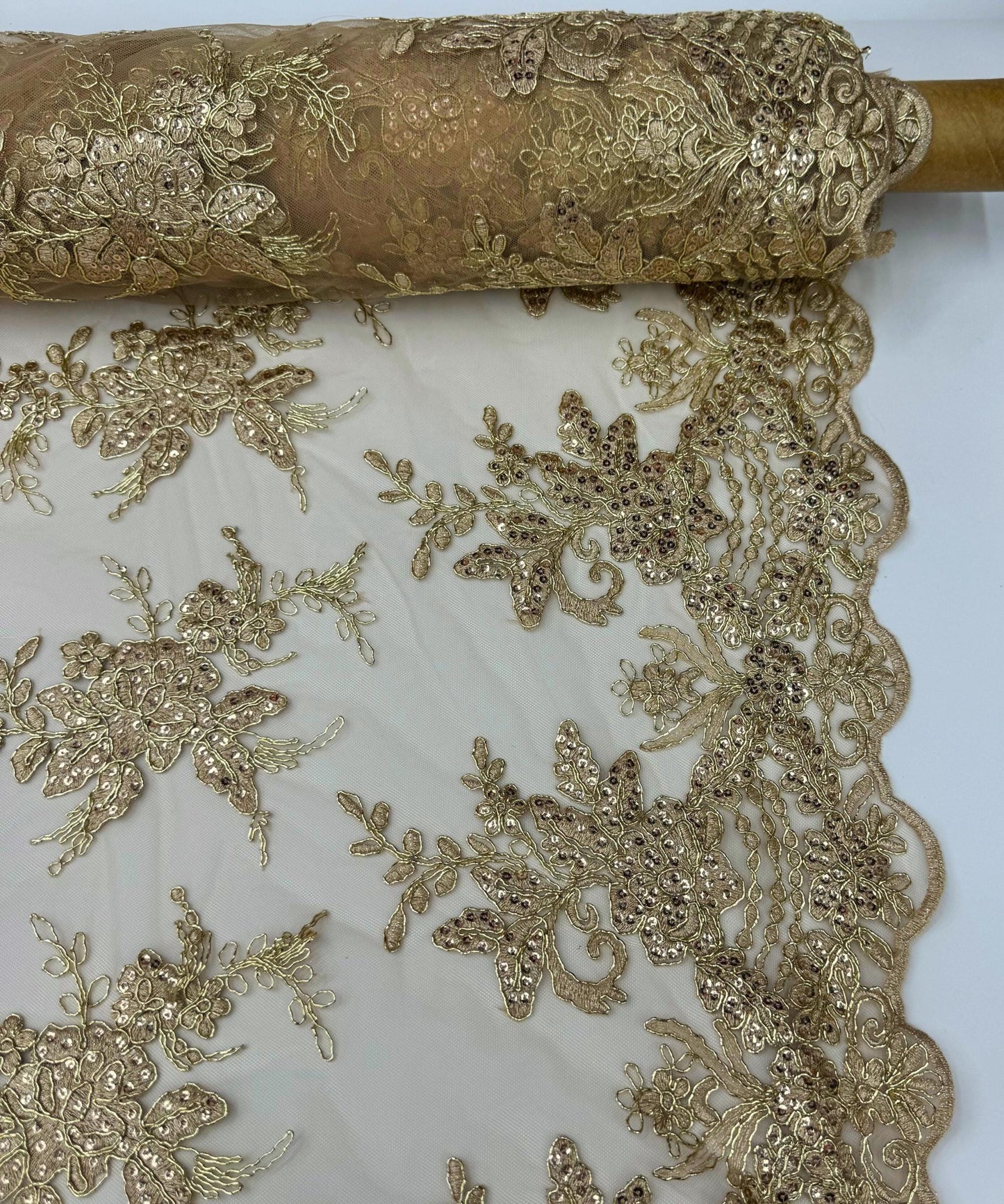 yard of champagne floral lace fabric with gold embroidery and sequins, detailing the intricate floral patterns and the mesh texture.