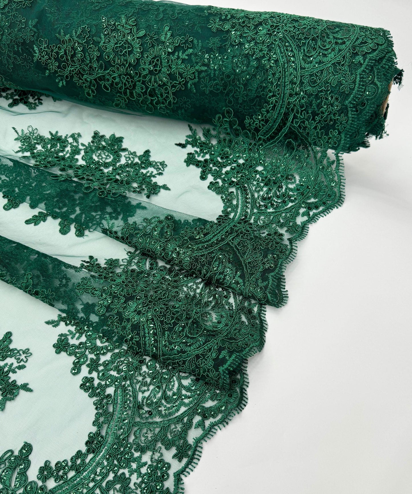yard of hunter green floral lace fabric with gold embroidery and sequins, detailing the intricate floral patterns and the mesh texture.