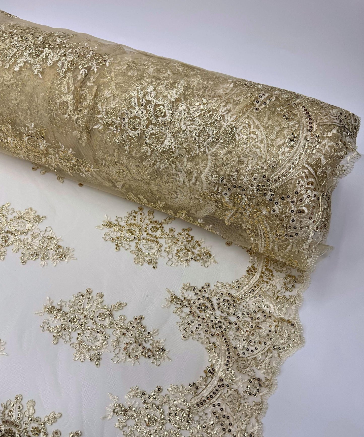 yard of gold floral lace fabric with gold embroidery and sequins, detailing the intricate floral patterns and the mesh texture.