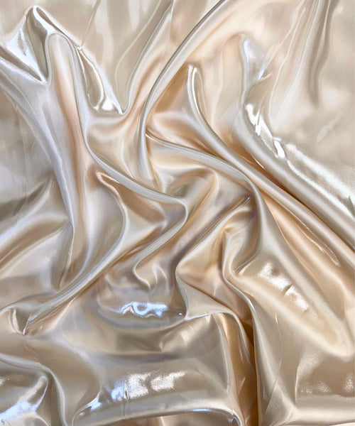 Champagne liquid bridal satin fabric with ultra-glossy finish, fluid drape, and silky smooth texture – perfect for gowns and elegant décor
