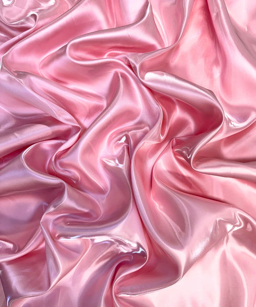 Baby Pink liquid bridal satin fabric with ultra-glossy finish, fluid drape, and silky smooth texture – perfect for gowns and elegant décor.