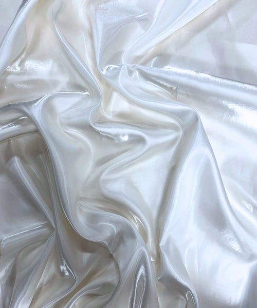 White liquid bridal satin fabric with ultra-glossy finish, fluid drape, and silky smooth texture – perfect for gowns and elegant décor.